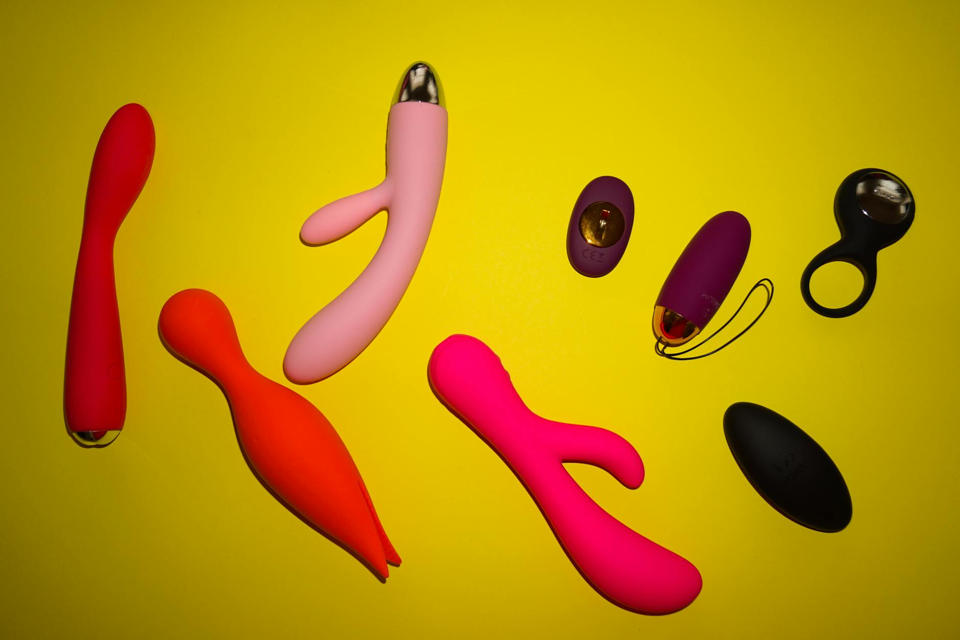 Hand holding a vibrator against a minimalist background, symbolizing modern intimacy and sexual wellness